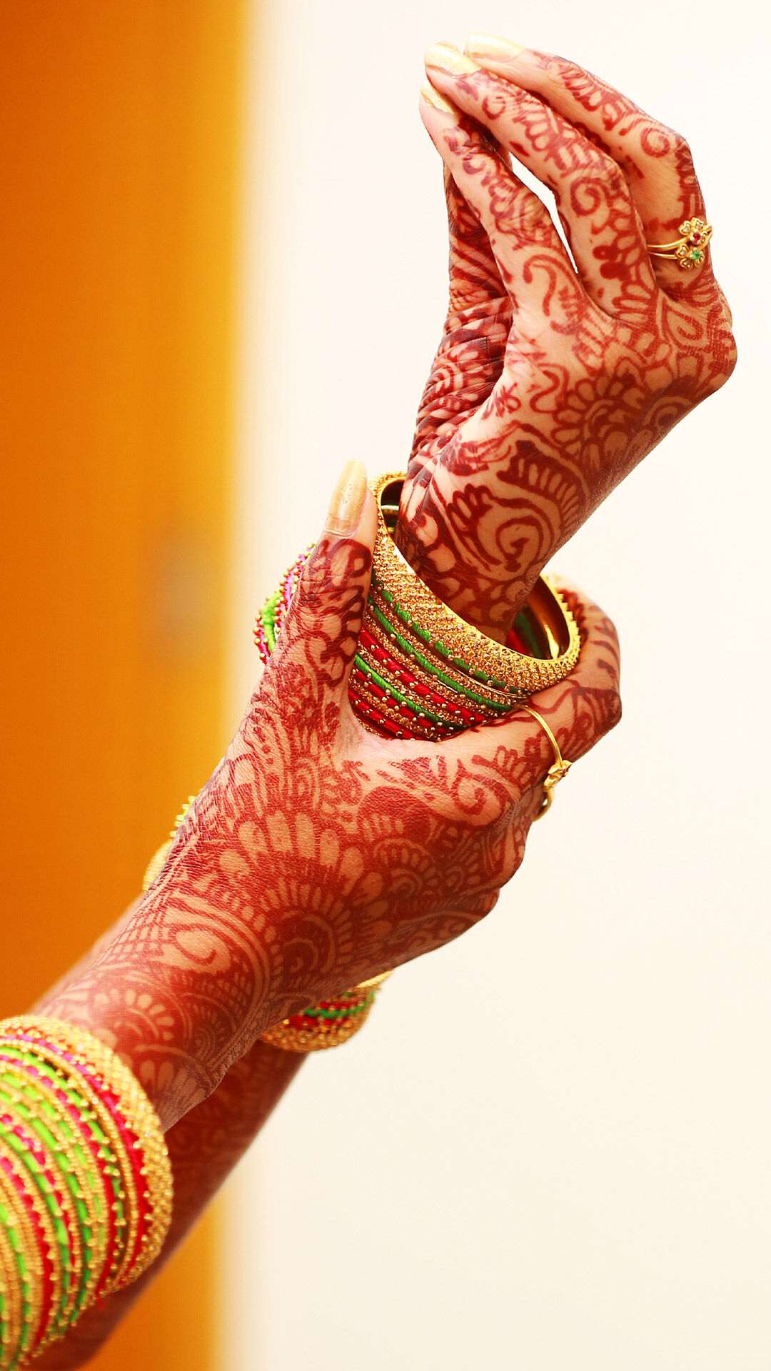 A bride adjusting her bangles during her bangle ceremony
